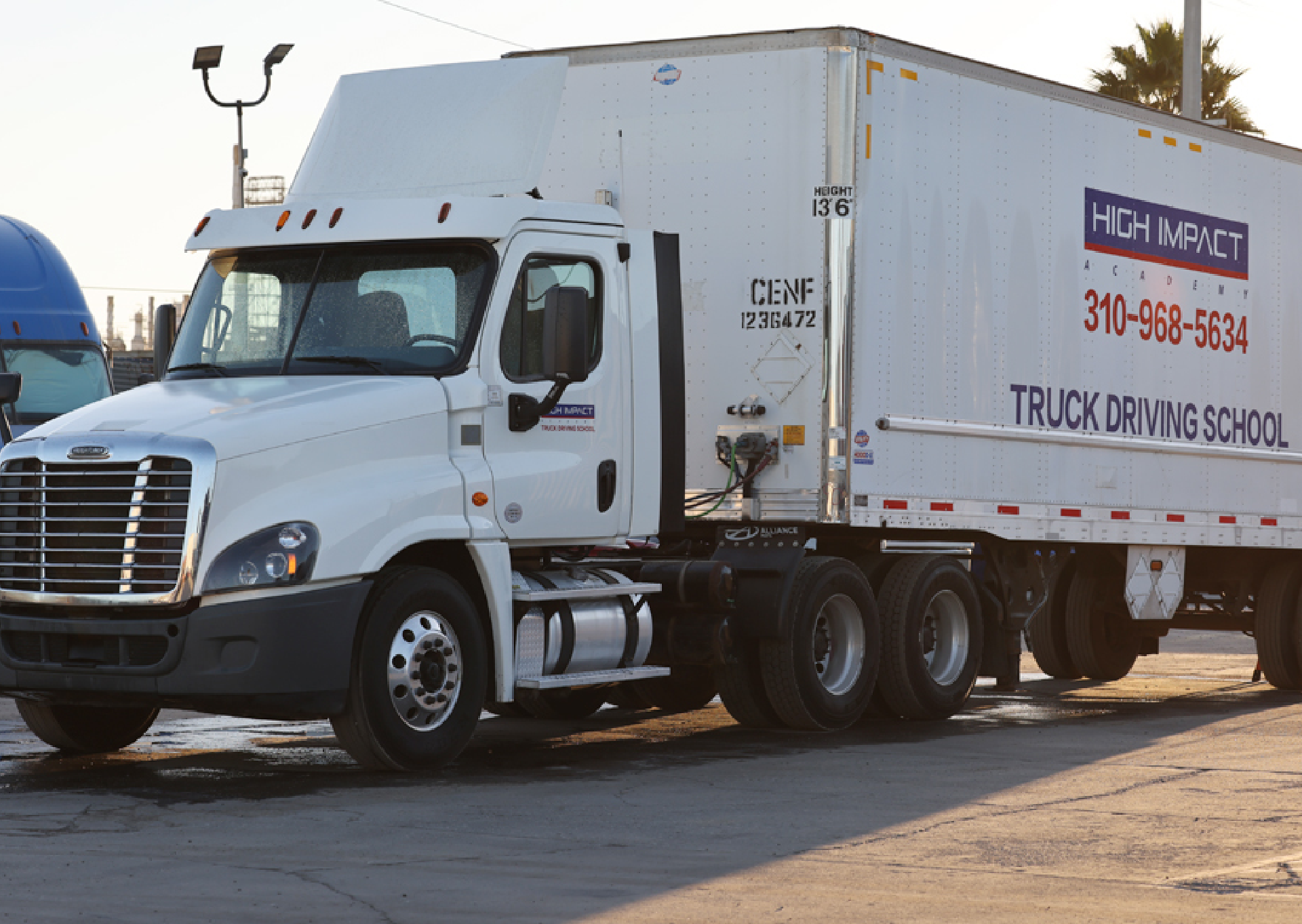 a large white semi-truck parked on the side of a road a large white semi-truck parked on the side of a road